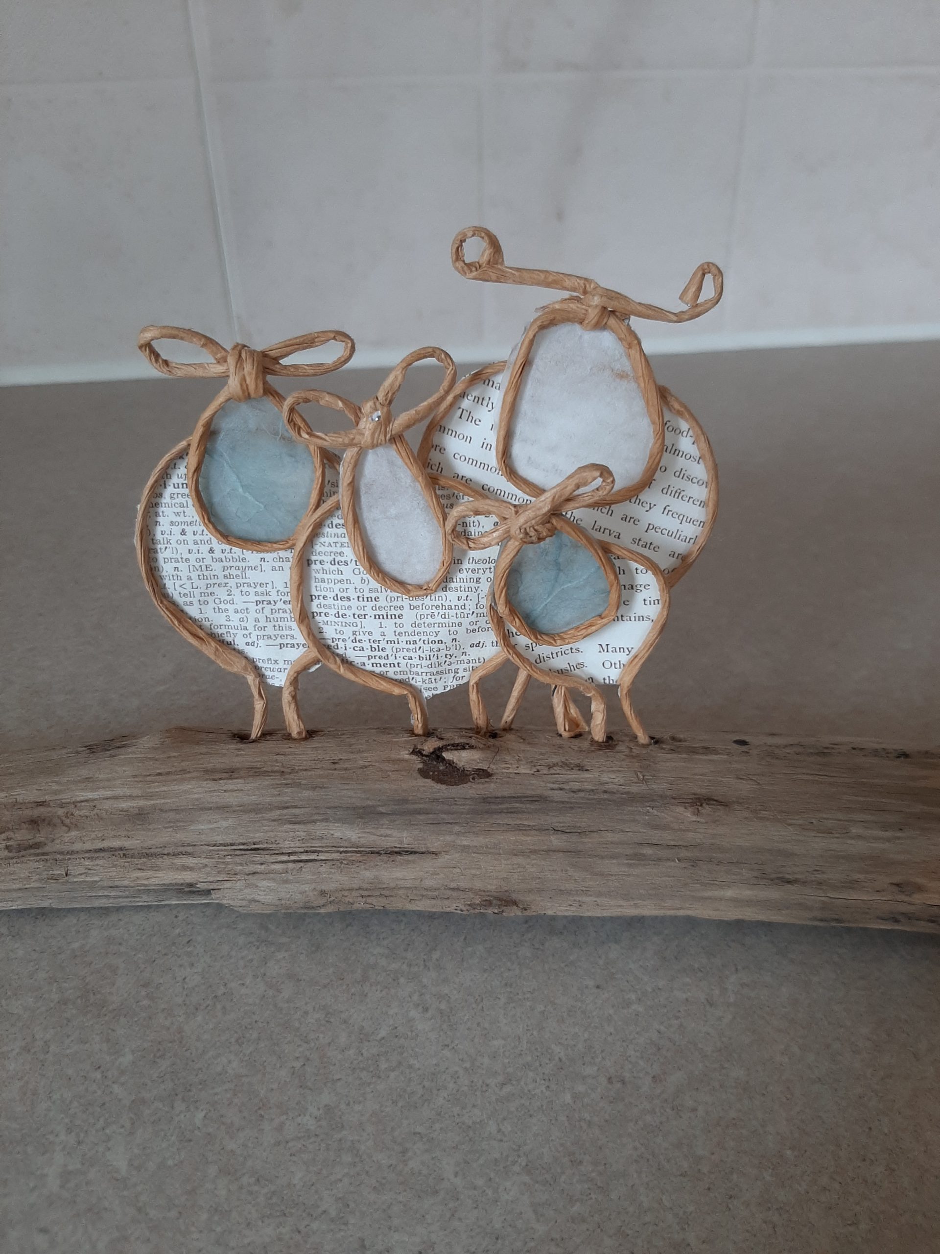 This is one of Kaylee's art creations of a family of sheep made with paper wire and paper on driftwood.