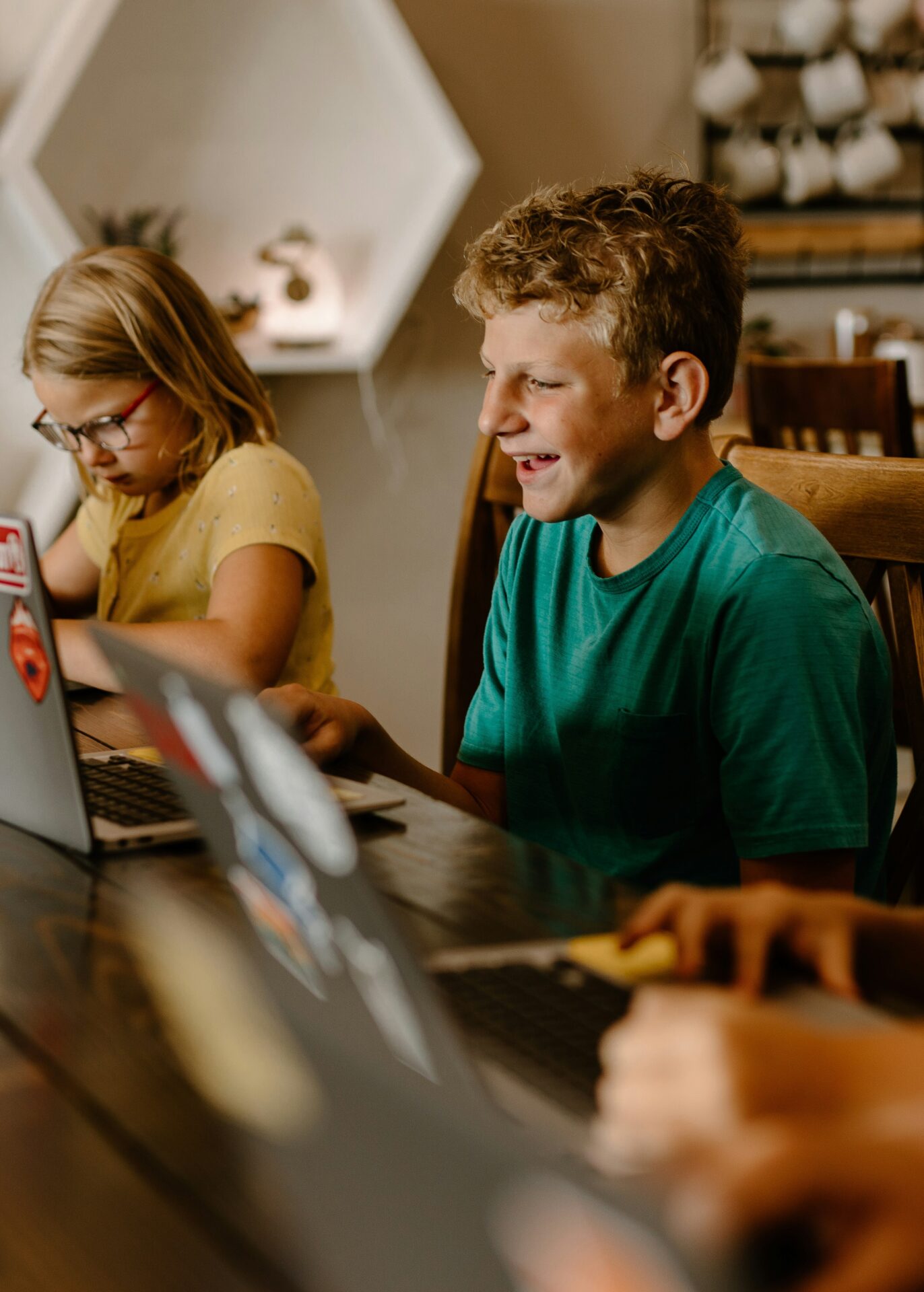 Students learning together with a laptop in a bright classroom